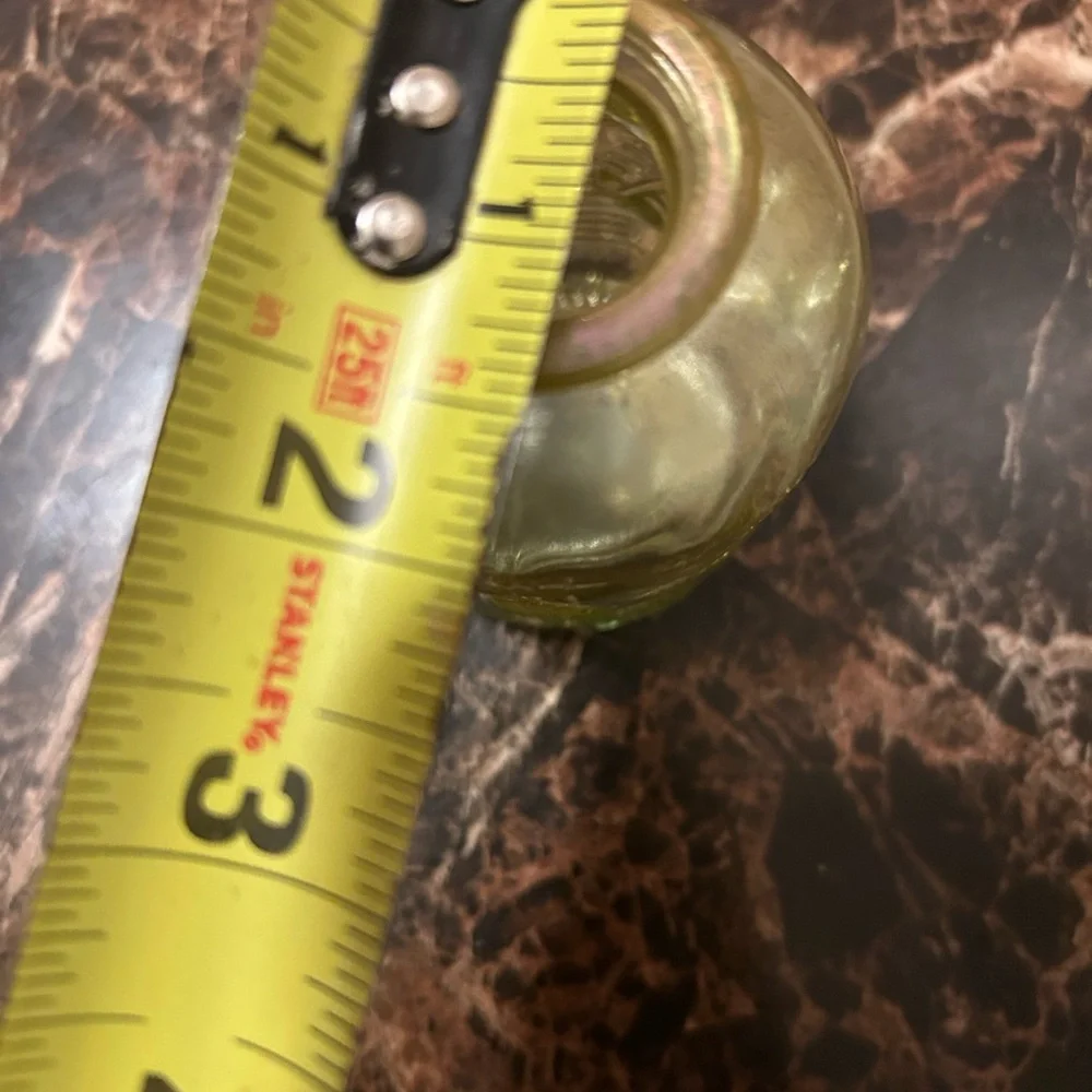 yellow iridescent glass vase with a leaf etching